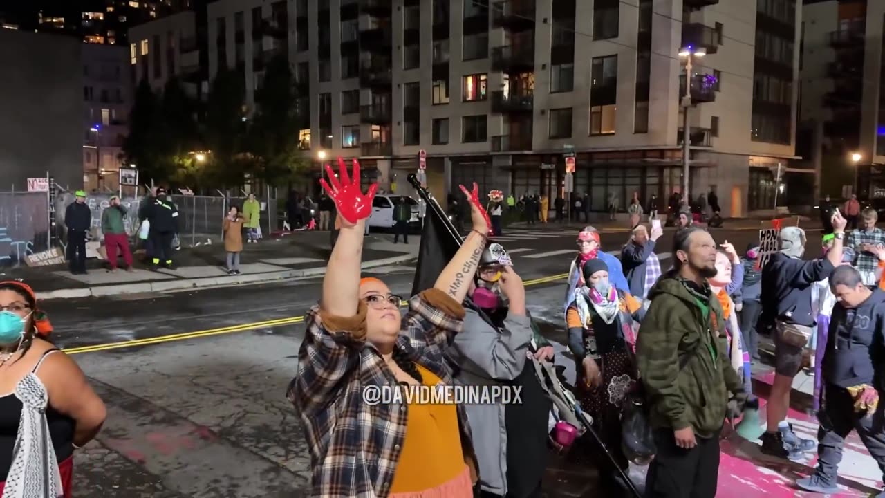 Anti-ICE Antifa protestors spill red paint on the driveway of the ICE building driveway and shout