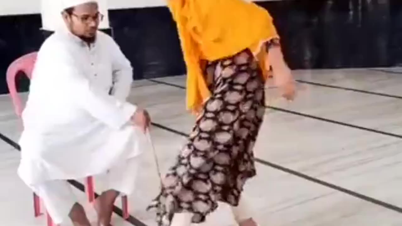 Islamic preacher educates little girls with a stick.