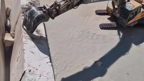 Excavator Knocks Down Travertine Wall