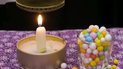 Green Foam Bead Melts Over Candle Flame