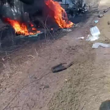 Roadway Lined With Burning Husks of Russian