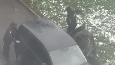 A mother and her child watch from the window as TCC workers