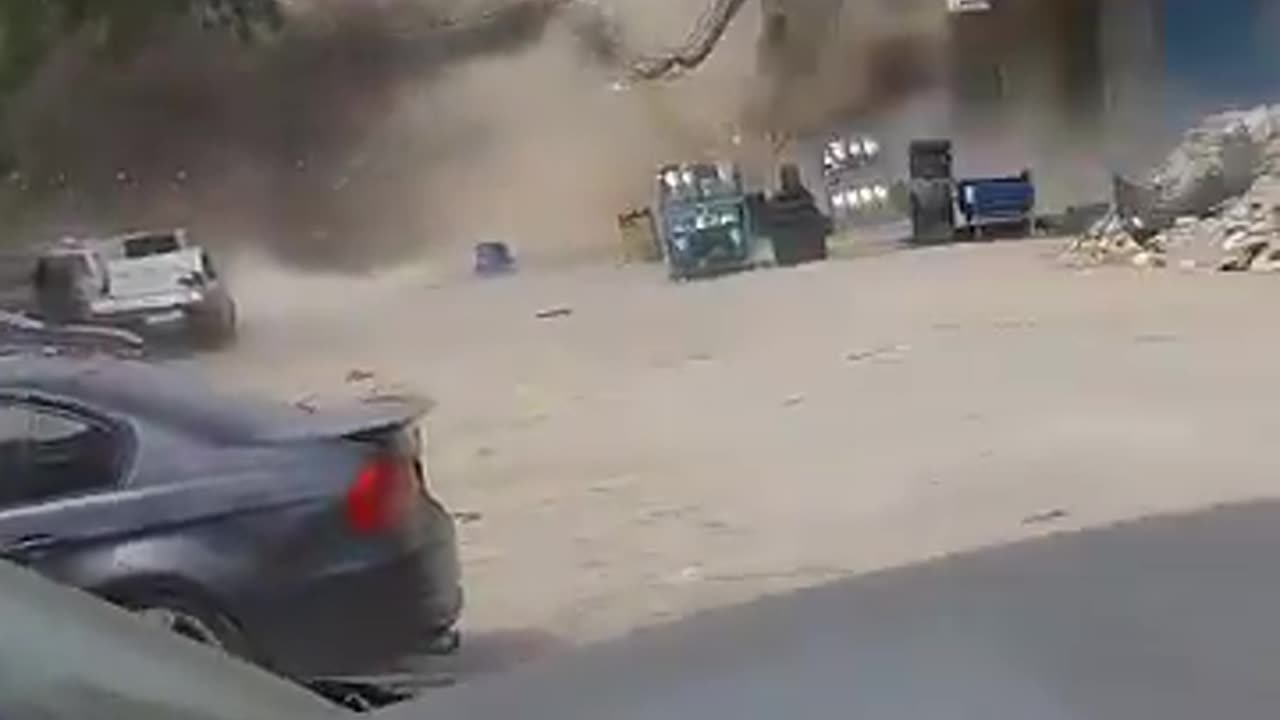 A building collapses in Beirut after being struck by Israel.