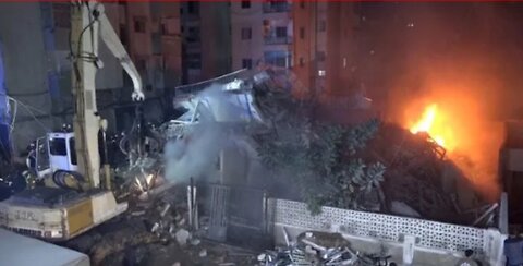 Building on fire in Tripoli collapses trapping two Lebanese Civil Defense members