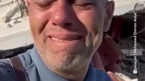 Journalist Mohamed al-Astal speaks in front of the ruins of his home