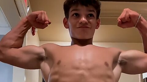 Teen boy flexing muscles