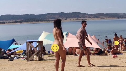 Brunette dancing naked at public beach