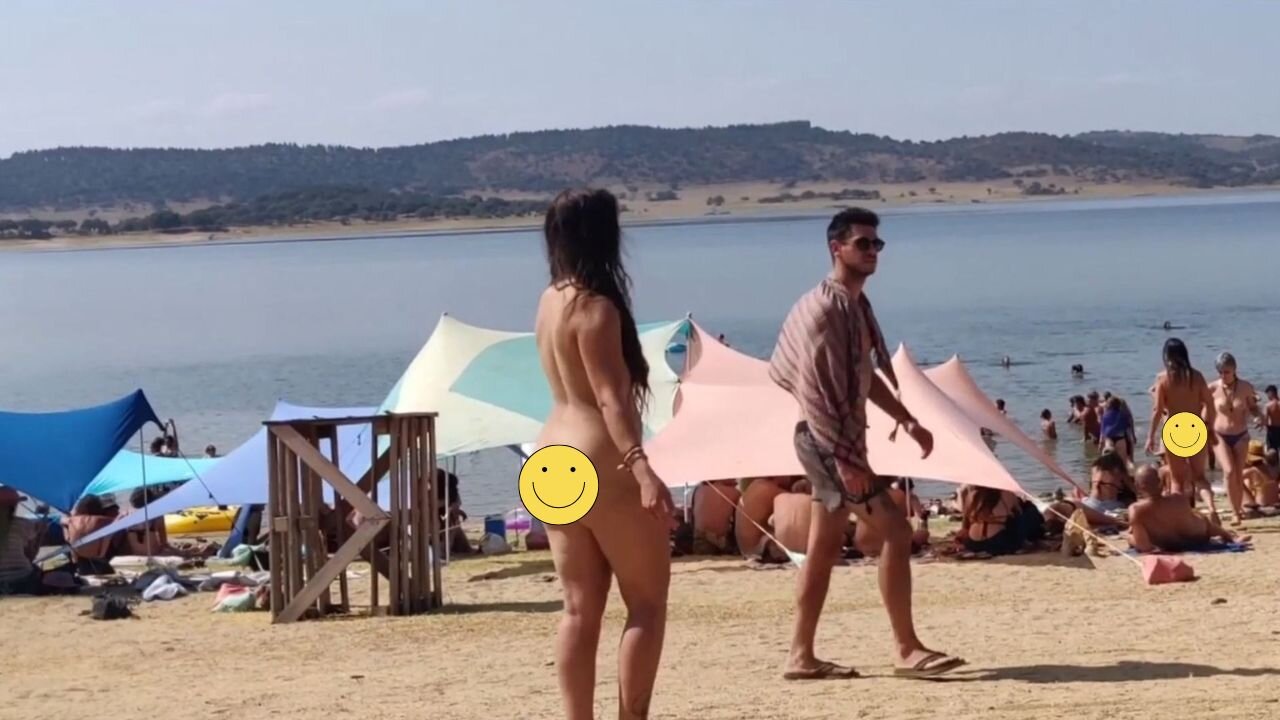 Brunette dancing naked at public beach
