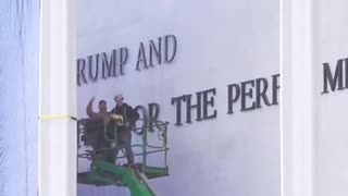 Workers were seen celebrating after installing the name “TRUMP” on the Trump