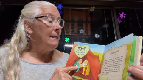 Reading God Loves Me book