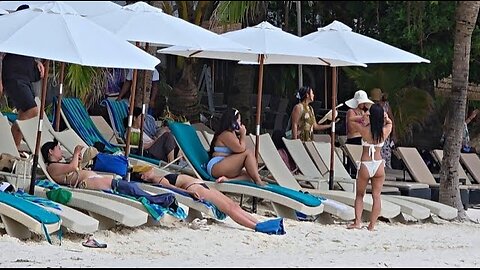 Having Fun And Sunbathing On The Beach During The Day On October 25, 2025