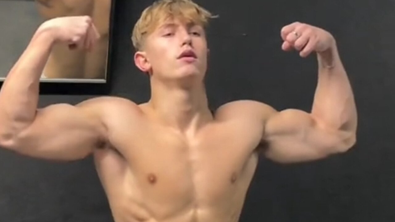 Young bodybuilder flexing muscles