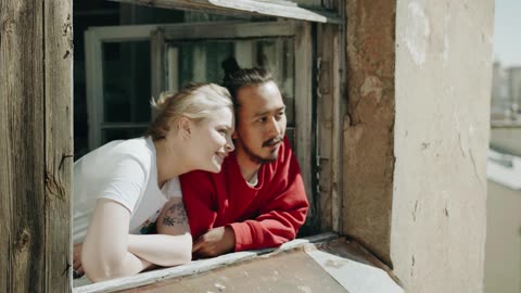 Couple Bonding By Their Home Window