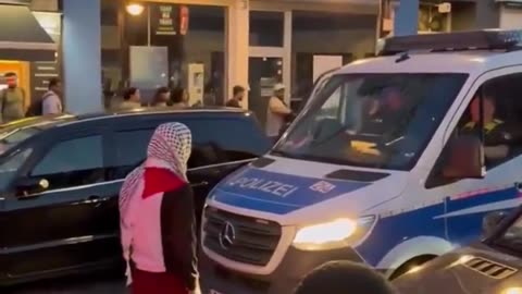 Muslim taunts police officer and tries to open his car door in Germany - cop does nothing