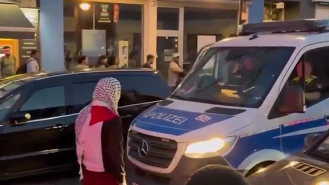 Muslim taunts police officer and tries to open his car door in Germany - cop does nothing