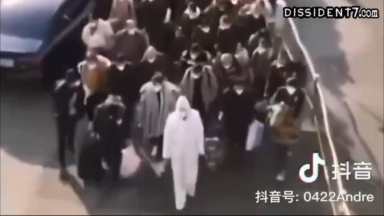 1 Chinese health official leading hundreds of people to a quarantine camp. (Expired Vaccine Passes)