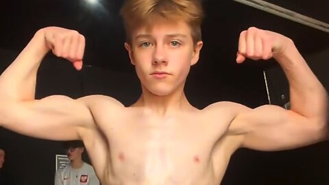 Teen boy flexing muscles