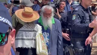 A woman in a kaffiyeh has been escorted by police away from the Bondi Pavilion