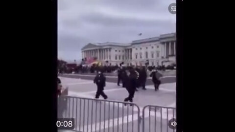 Capitol policeman waving the J6 crowd towards the Capitol.