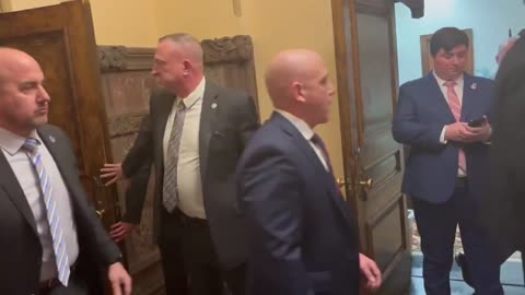 WATCH: TOM HOMAN eats an apple and smirks as protesters scream and chant at him.