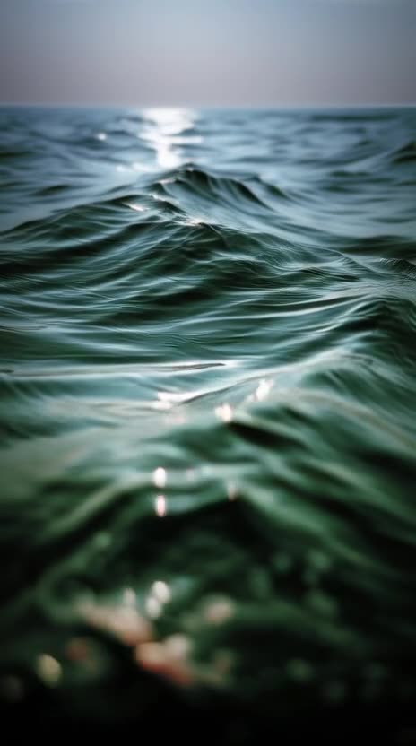 Create a video of a ocean surface lines drifting gently to the right; open ocean seascape