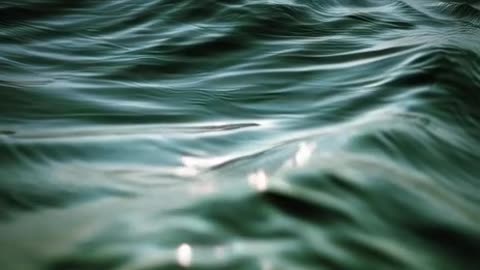 Create a video of a ocean surface lines drifting gently to the right; open ocean seascape