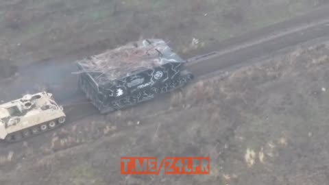 Russian Turtle tank tows a Ukrainian APC