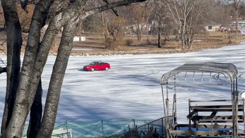 Cars Drive Down Frozen Fox River