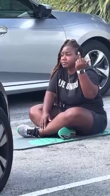 Fat diverse woman park's herself in parking spot.