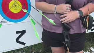 🏹 Barefoot and focused — she draws her recurve bow and releases in slow motion.