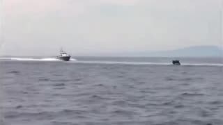 Video shows Greek coastguard vessels signaling to a dinghy of illegal migrants
