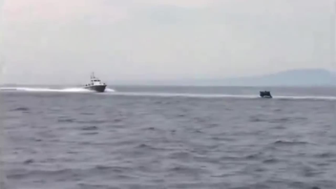 Video shows Greek coastguard vessels signaling to a dinghy of illegal migrants