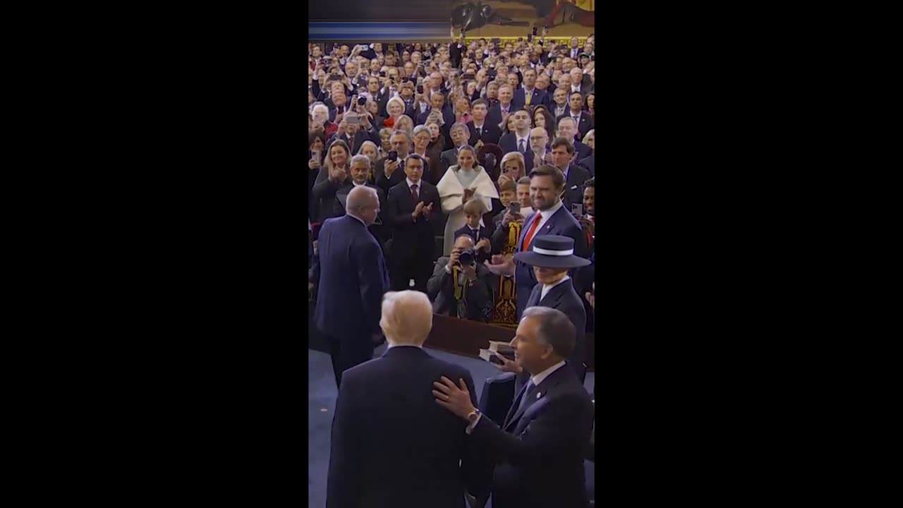 Melania's hat comes between kiss with Donald Trump at inauguration