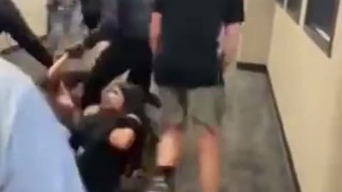 Girls are fighting in school hallway