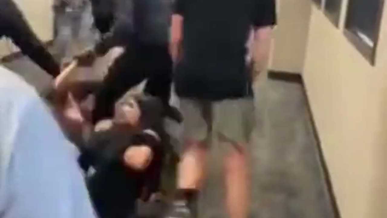 Girls are fighting in school hallway