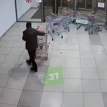 supermarket worker accidently drops row of shopping carts on customer