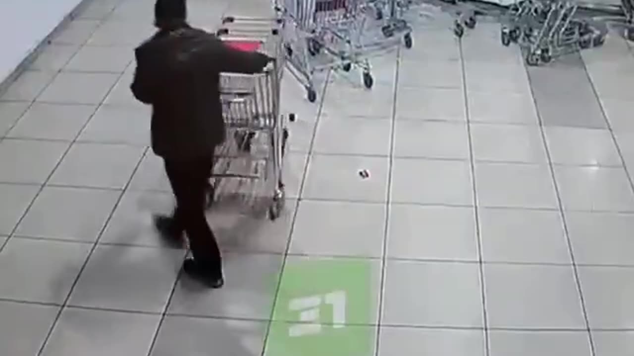 supermarket worker accidently drops row of shopping carts on customer