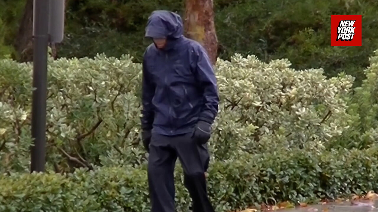 Mitt Romneys brother strolls through rain days after estranged wife found dead