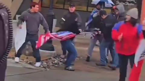 Anti-deportation mob attacks a man, tearing down his American flag in Dallas.