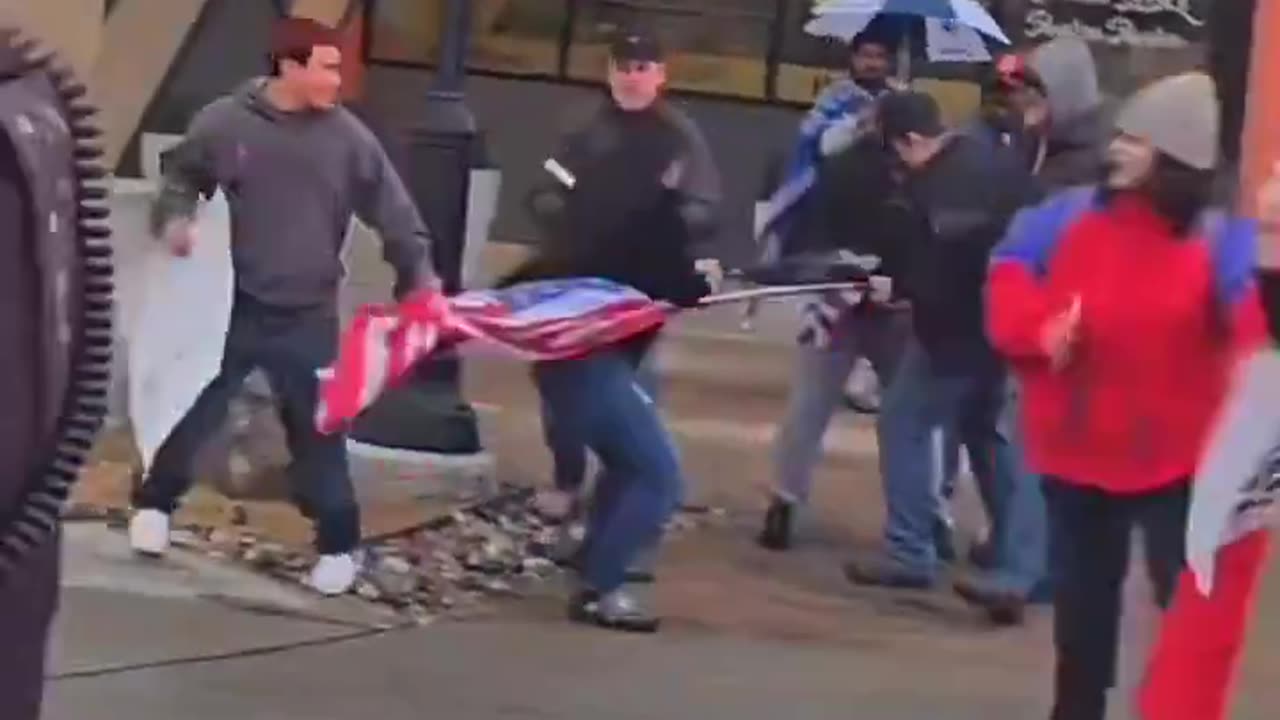 Anti-deportation mob attacks a man, tearing down his American flag in Dallas.