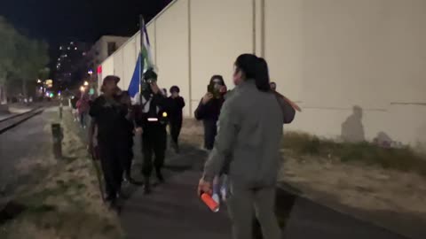 Antifa rioters continue to try to attack an Asian man outside the ICE facility.
