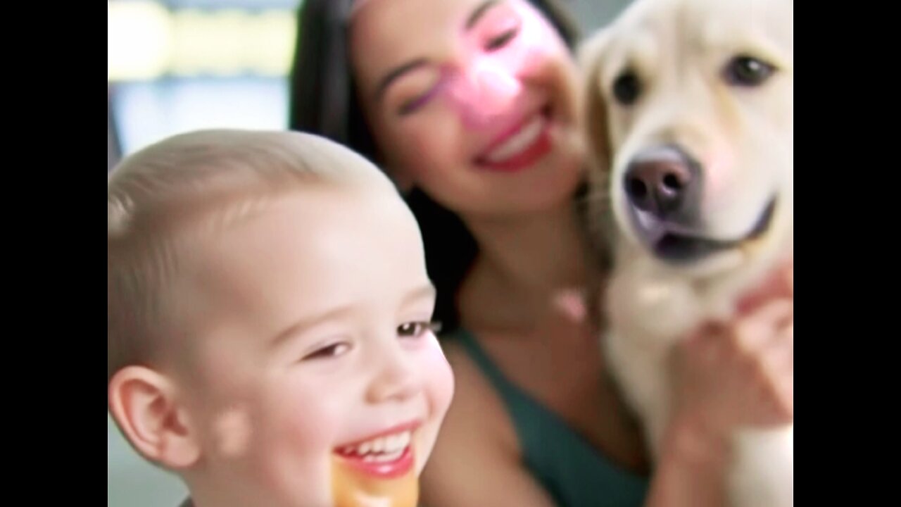 ♡A little boy eating a hamburger and a retriever dog.