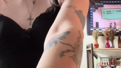 She is being a feminine goth tgirl