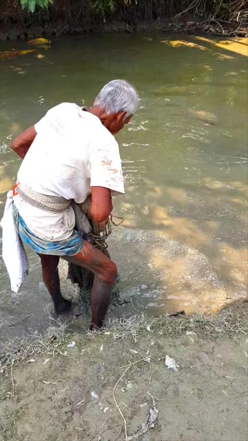 Uncle fisherman fishing in village pond