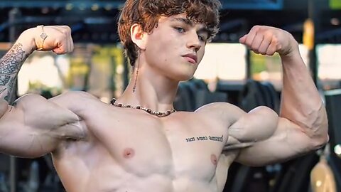 Handsome aesthetic bodybuilder flexing big biceps