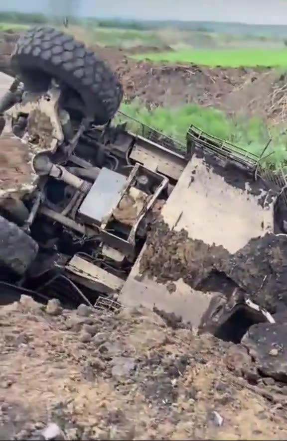 Two International MaxxPro armored vehicles and a pickup truck