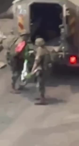 Israeli soldiers steal an electric scooter during a raid