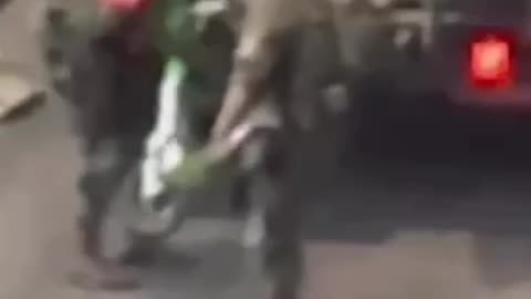 Israeli soldiers steal an electric scooter during a raid