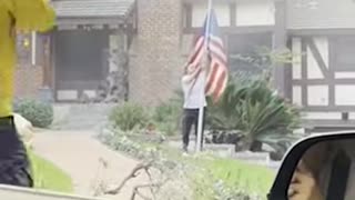 Man rescues American flag from stranger's yard as home burns behind him