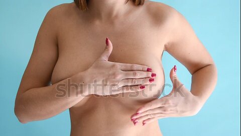 Naked woman exams her breast for lumps and signs of oncology. 4k resolution video.